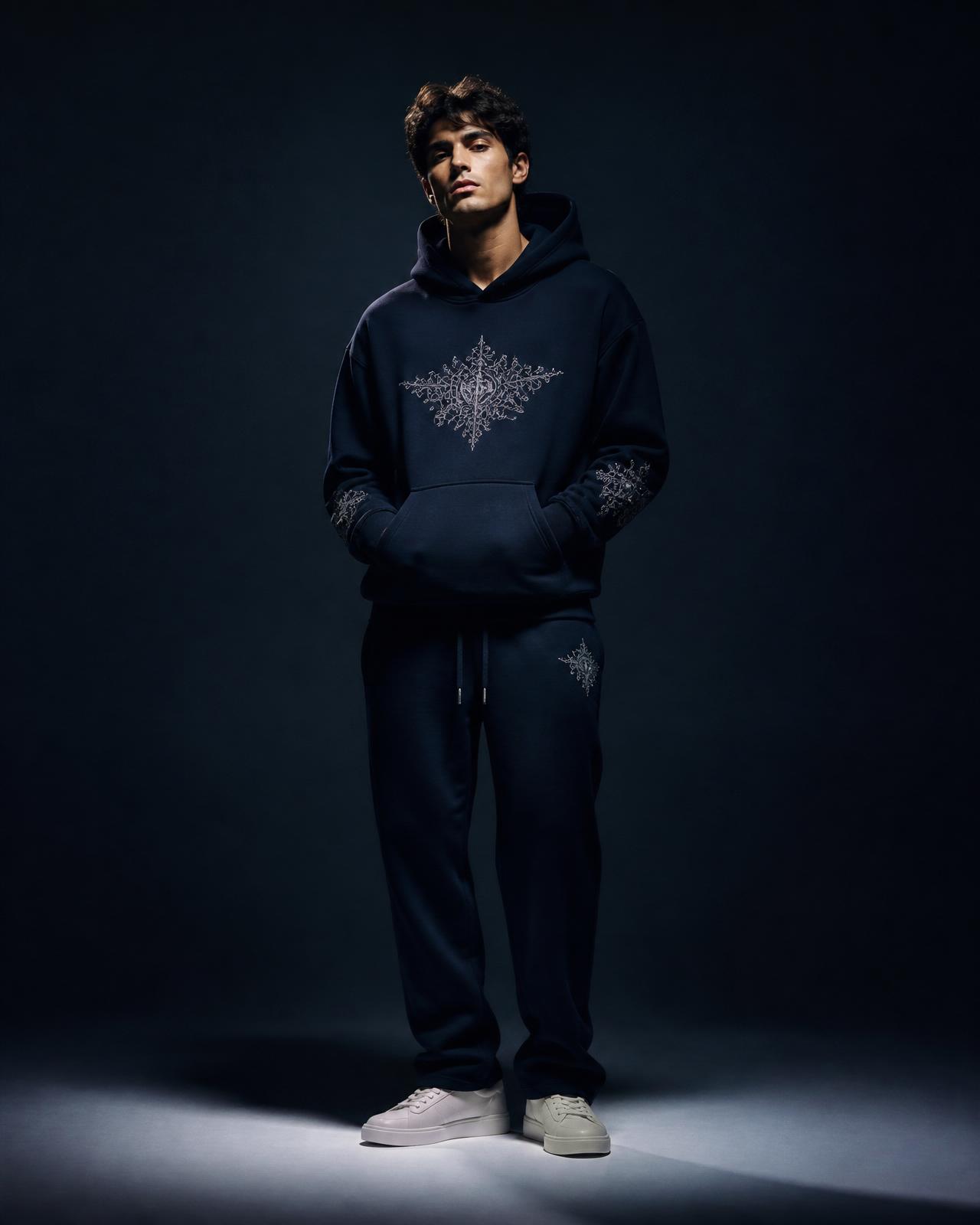 LUXJUR Drop 001 — model wearing embroidered navy hoodie and pants